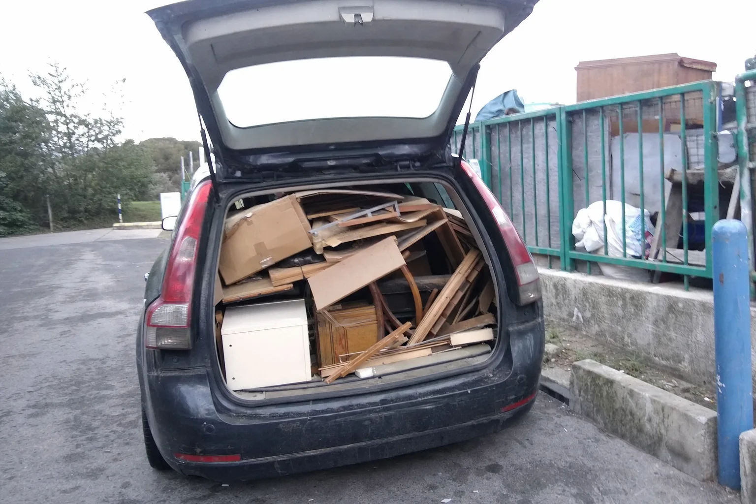 Voiture chargée de cartons et de vieux meubles à la déchetterie